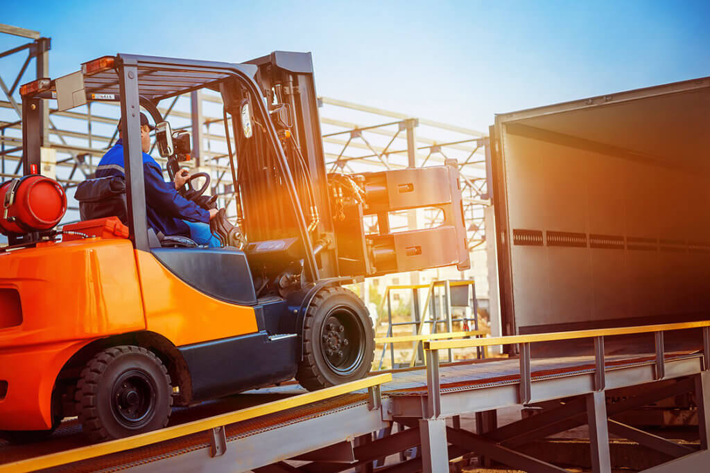 Single Sourcing Reduces Machine Builder Costs - Forklift loading factory automation and industrial control products onto a lorry image