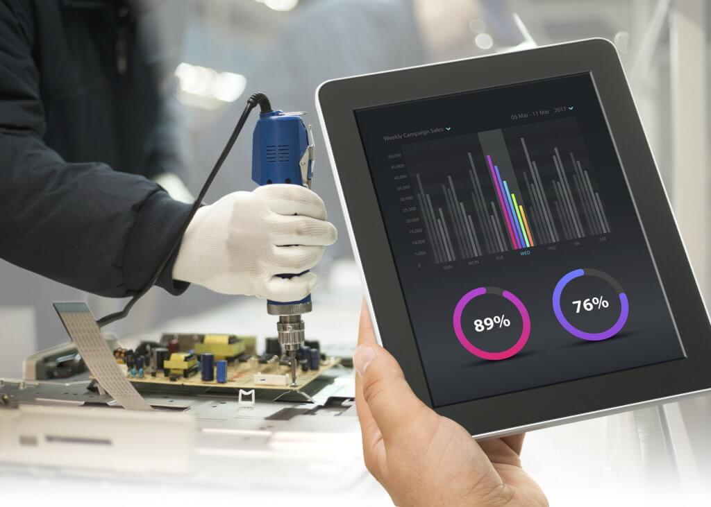 Technicians working in the factory showing how Integrating Manual Assembly Cells into Factory Automation Systems can work