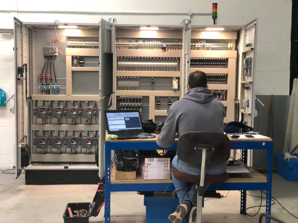 Driving motors to better efficiency image showing an automation engineer at his desk